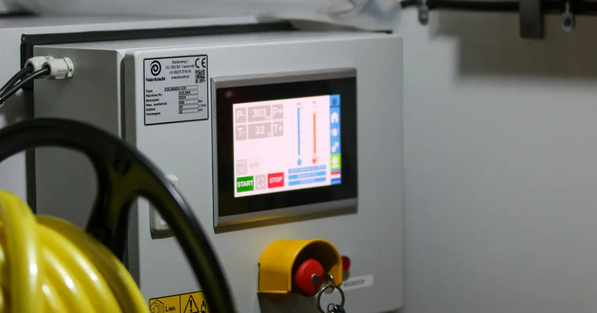 Machine control cabinet with a touchscreen, emergency stop and key switch, an example of control panel assembly